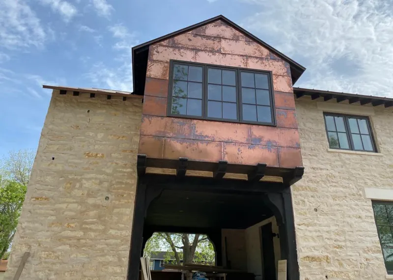 Copper metal panel facade on a stone building for Skylight Installation in Vineyard